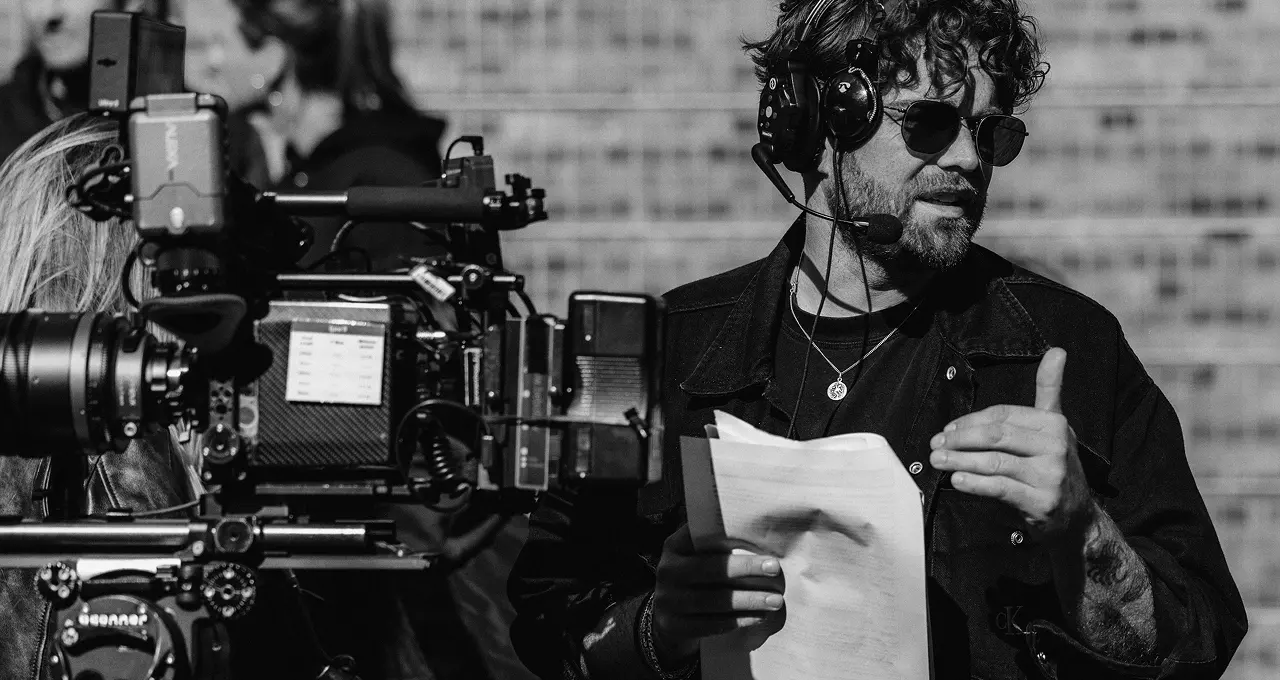 Morgan Grunefeld directing on set with headset and script