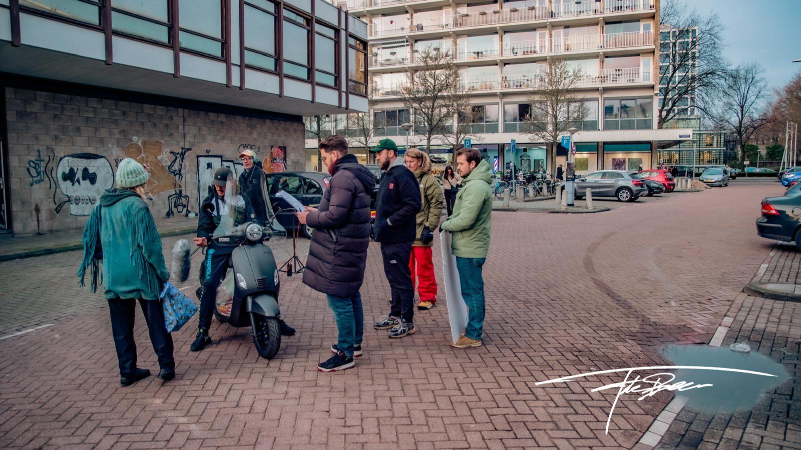 Film crew preparing a scene with a scooter on an Amsterdam street